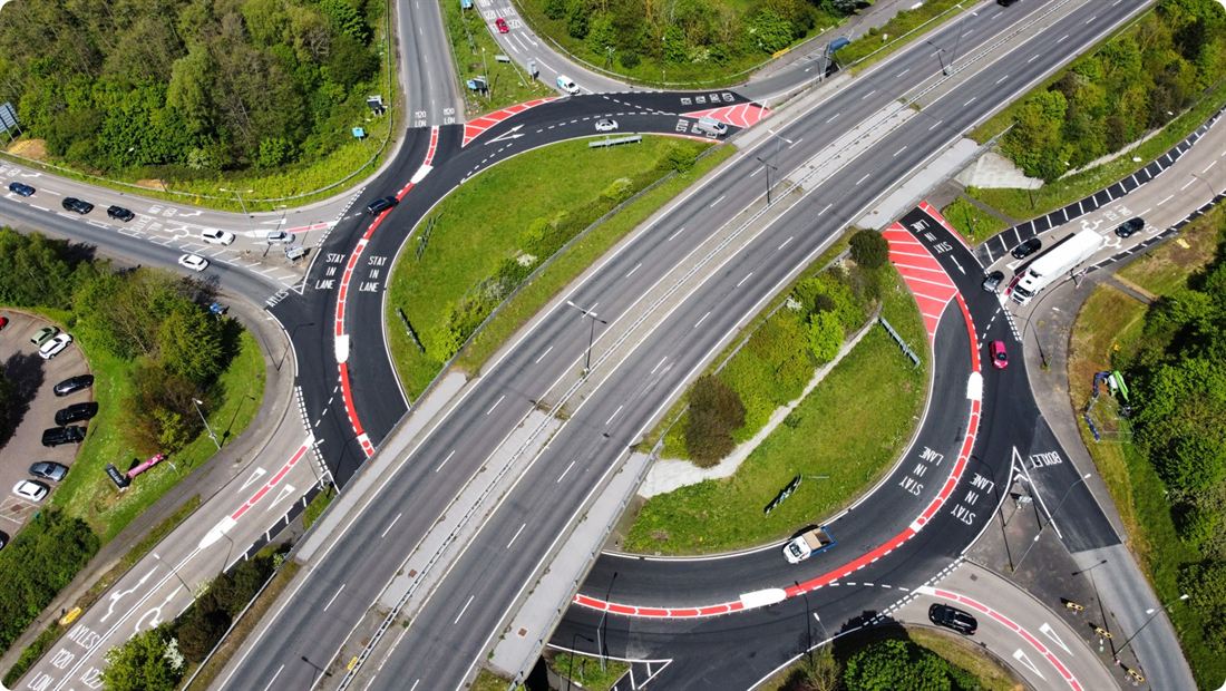Aerial view of the Running Horse Roundabout at Maidstone after conversion, showing the spiral lane markings, hatched separators and the flyover crossing the junction.